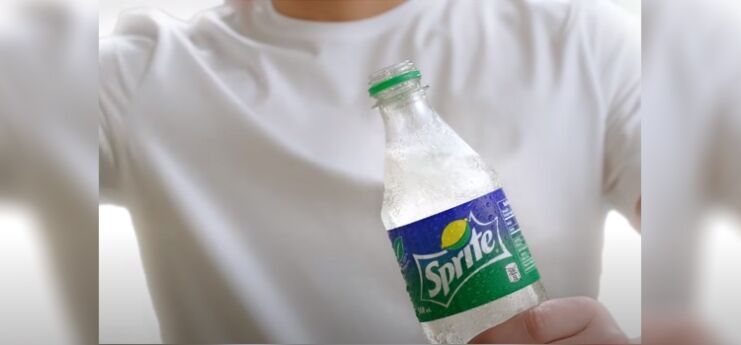 Man Holding Bottle of Sprite