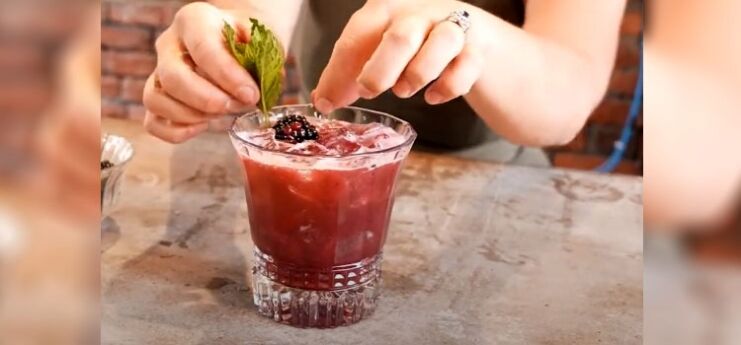 Woman Making Blackberry Smash Bourbon Cocktail