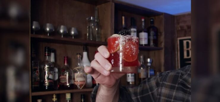 Man Holding Bottle of Blackberry Margaritas